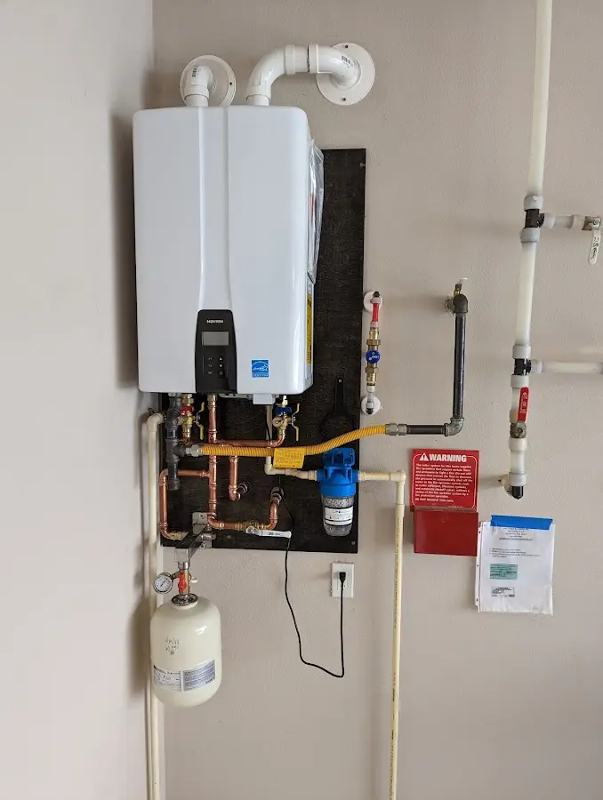 Professional plumber installing copper piping in a Mount Holly home